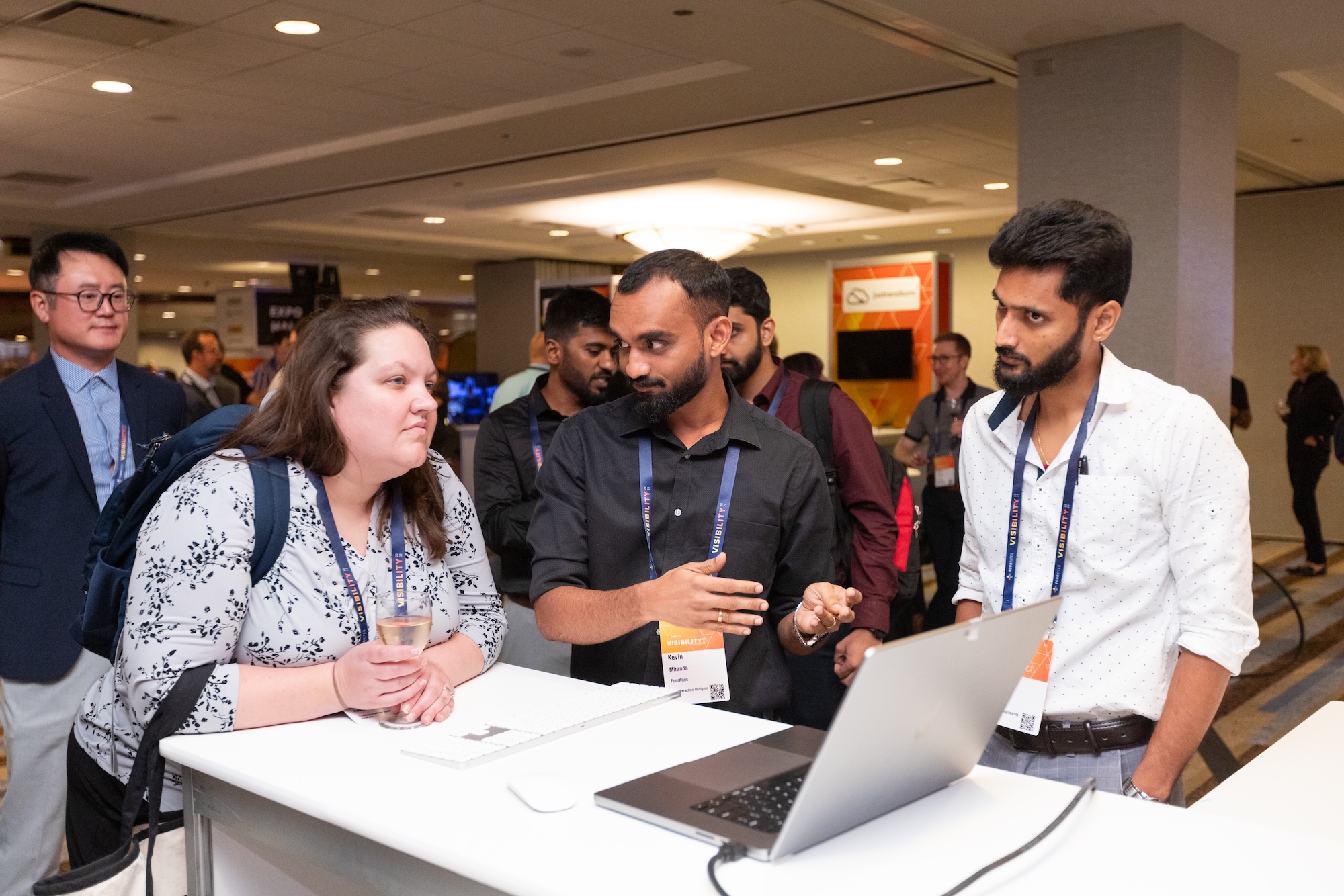 A FourKites team member demonstrates My Workspace to conference attendees at a booth.